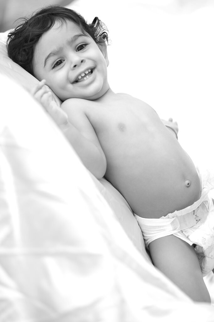 Black and white baby photography Auckland session of smiling infant in diaper