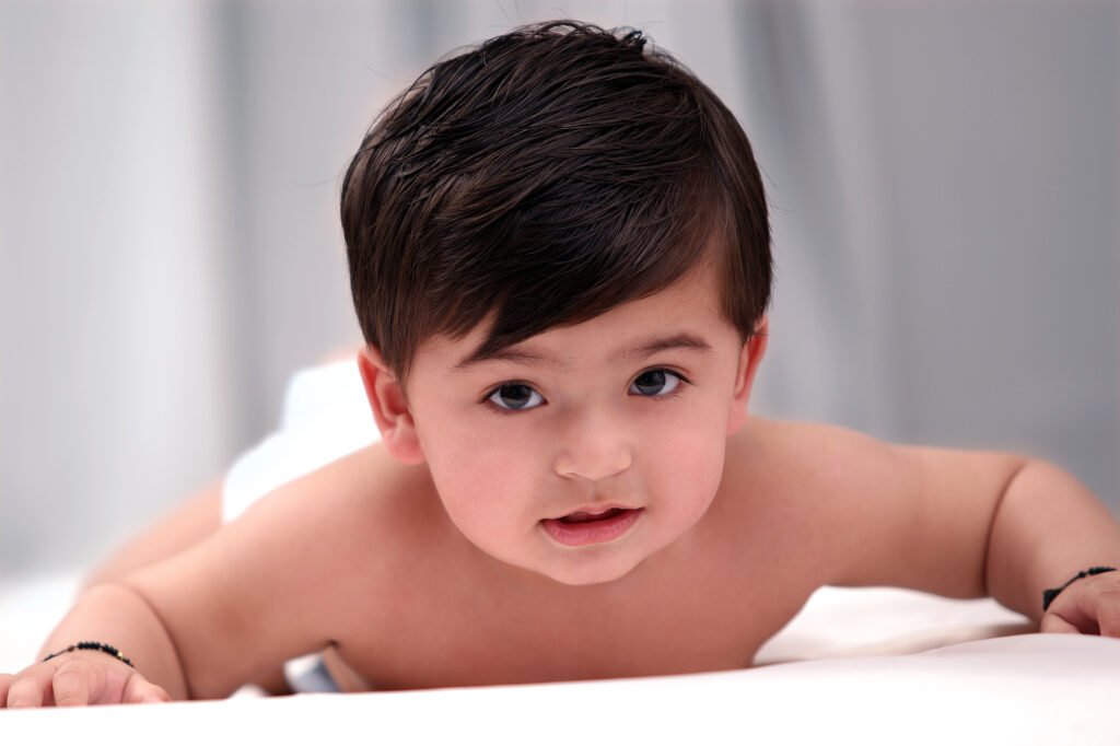 Baby photographer Auckland studio session of cute infant crawling