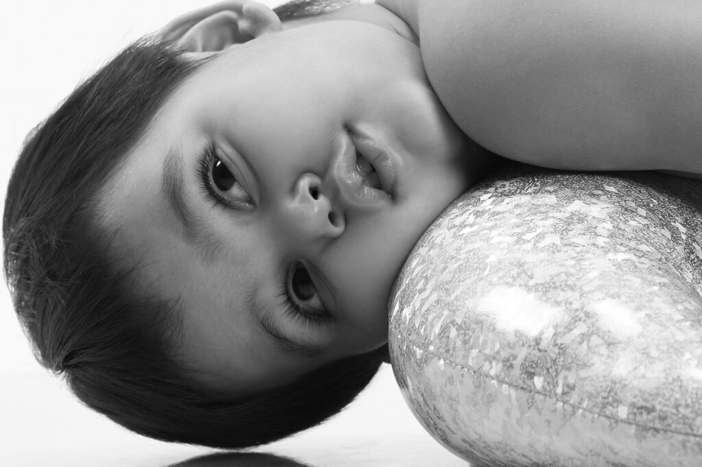 Black and white baby photography Auckland session of cute toddler lying down