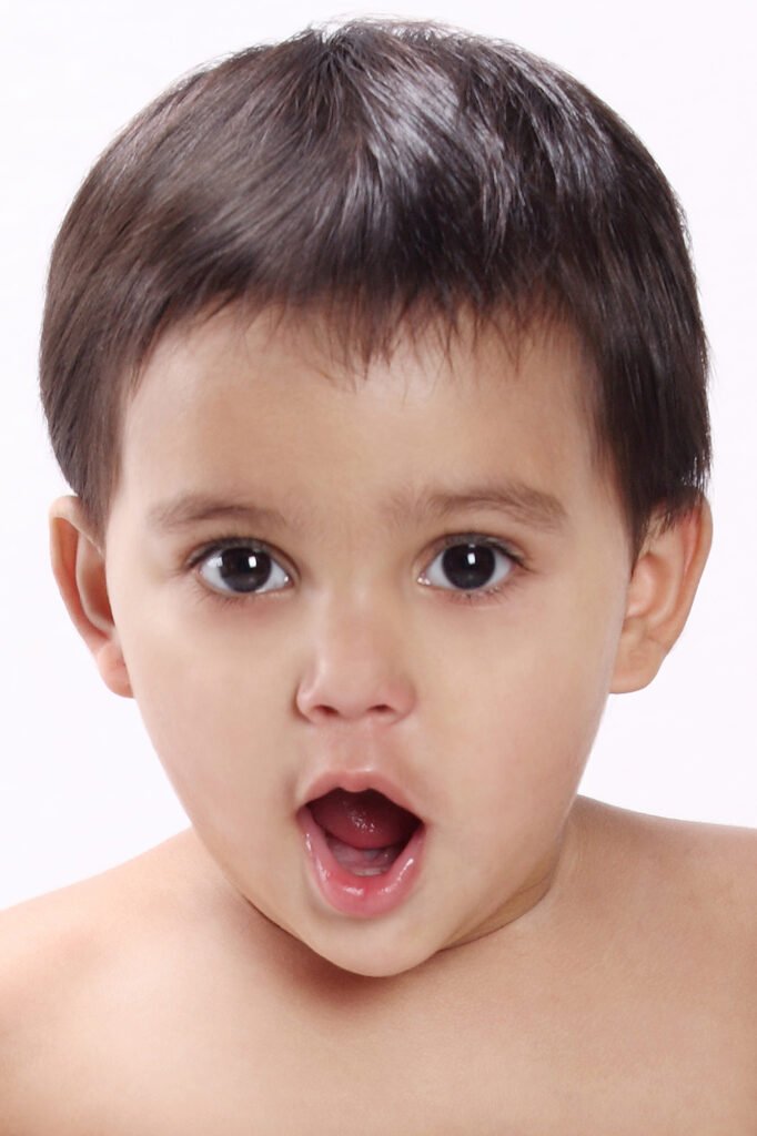 Baby photographer Auckland studio session of surprised toddler with open mouth