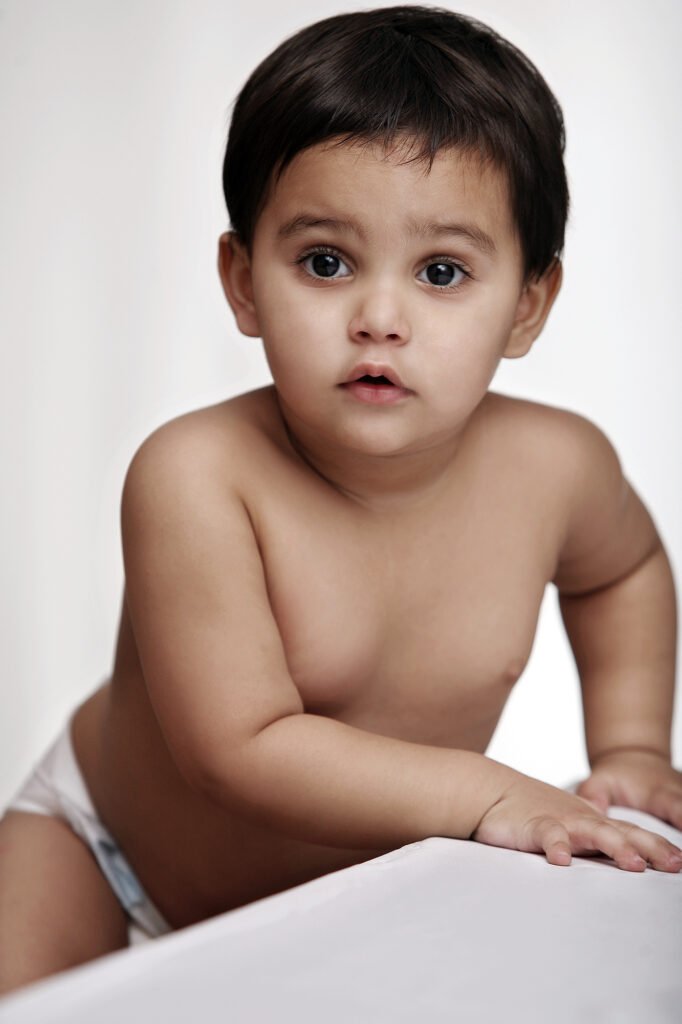 Baby photographer Auckland studio session of curious infant with big dark eyes