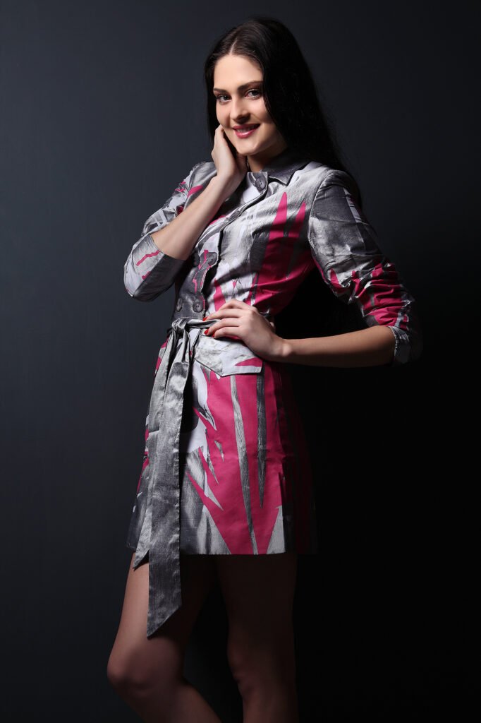 High fashion photography Auckland of smiling model in silver pink dress
