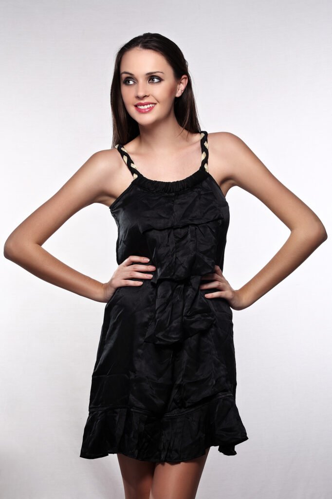 Professional apparel photography Auckland of smiling model in black dress