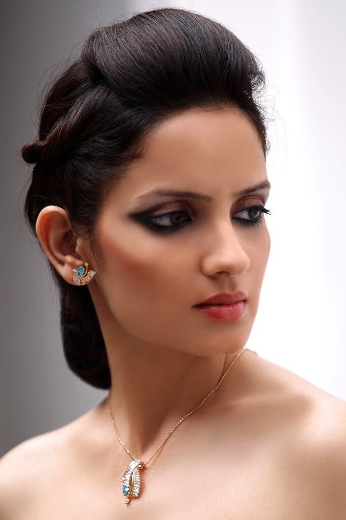 Commercial jewellery photography Auckland of model wearing gold blue stone pendant necklace