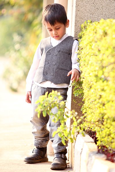 Kids clothing photography Auckland session of little boy in grey waistcoat
