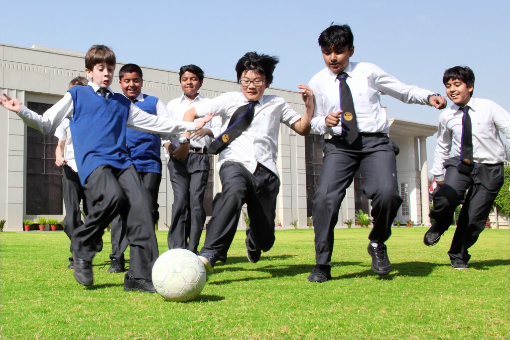 School lifestyle photography Auckland of kids in uniform playing football