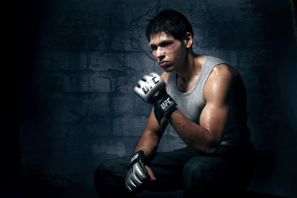 Athletic male fitness model wearing UFC gloves in a dramatic concept studio photoshoot by Auckland photographer Jassa Studio
