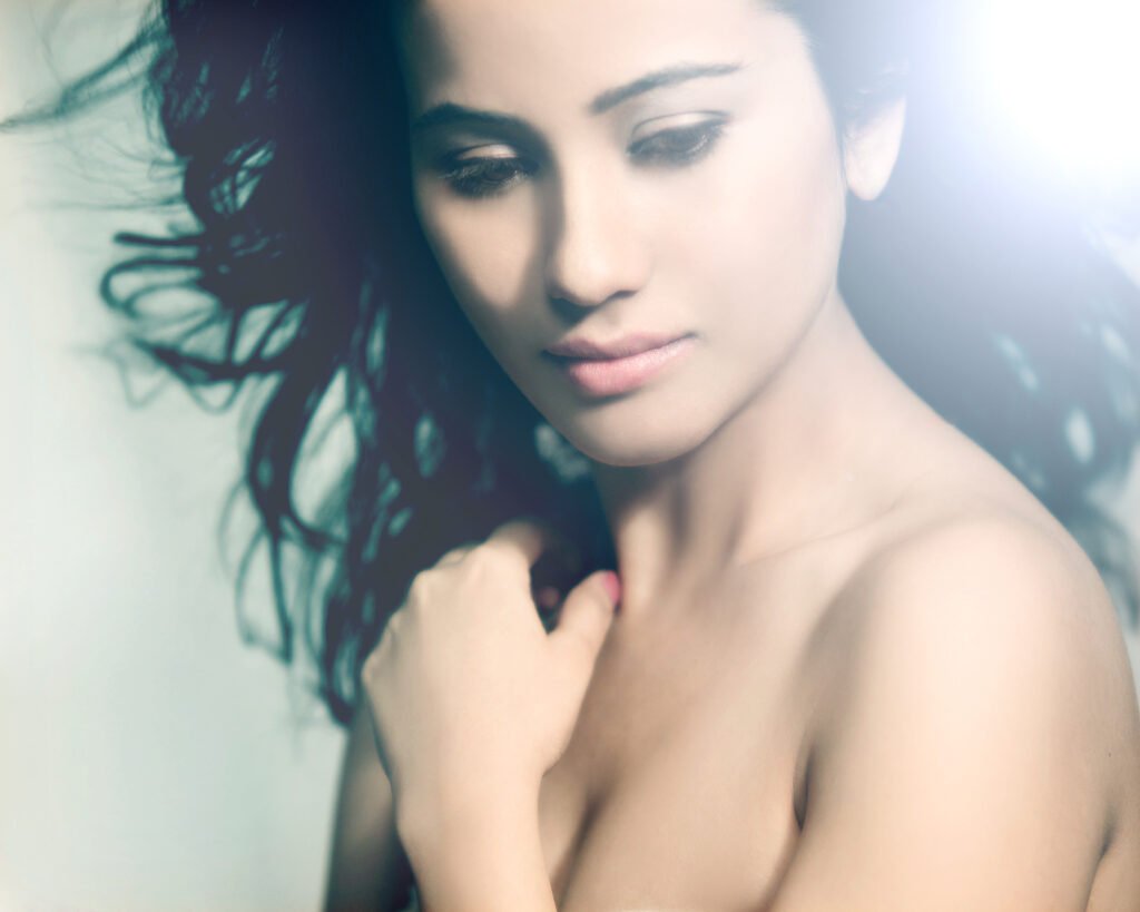 Soft focus fine art beauty portrait of a female model with blowing hair during a studio photoshoot by Auckland photographer Jassa Studio