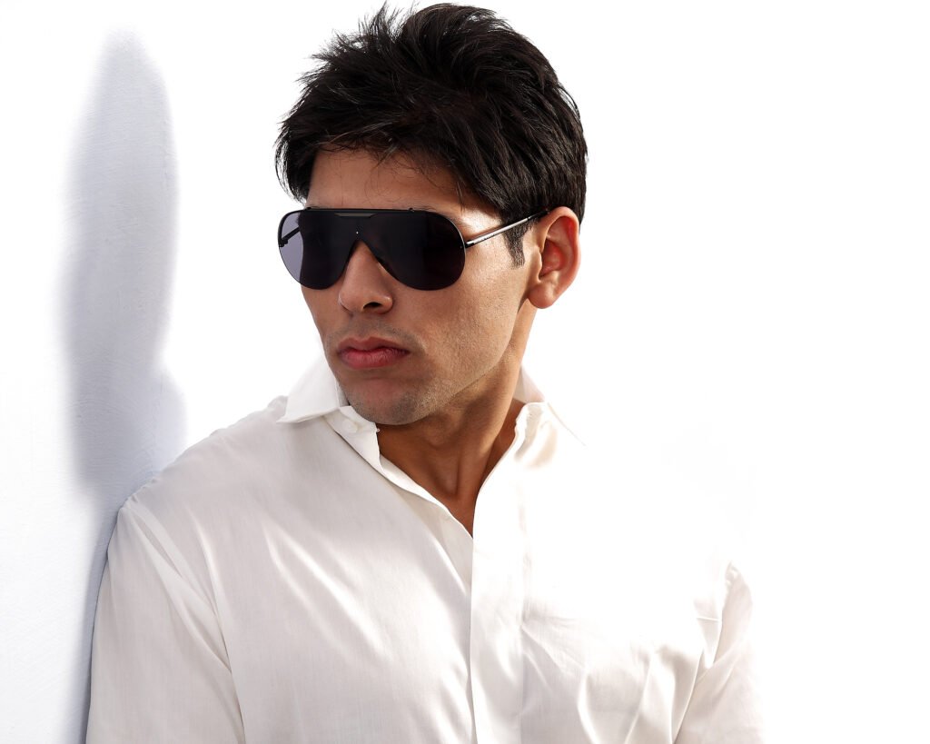 Punjabi singer and songwriter Leo Grewal wearing sunglasses in a studio portrait by Auckland portrait photographer Jassa Studio
