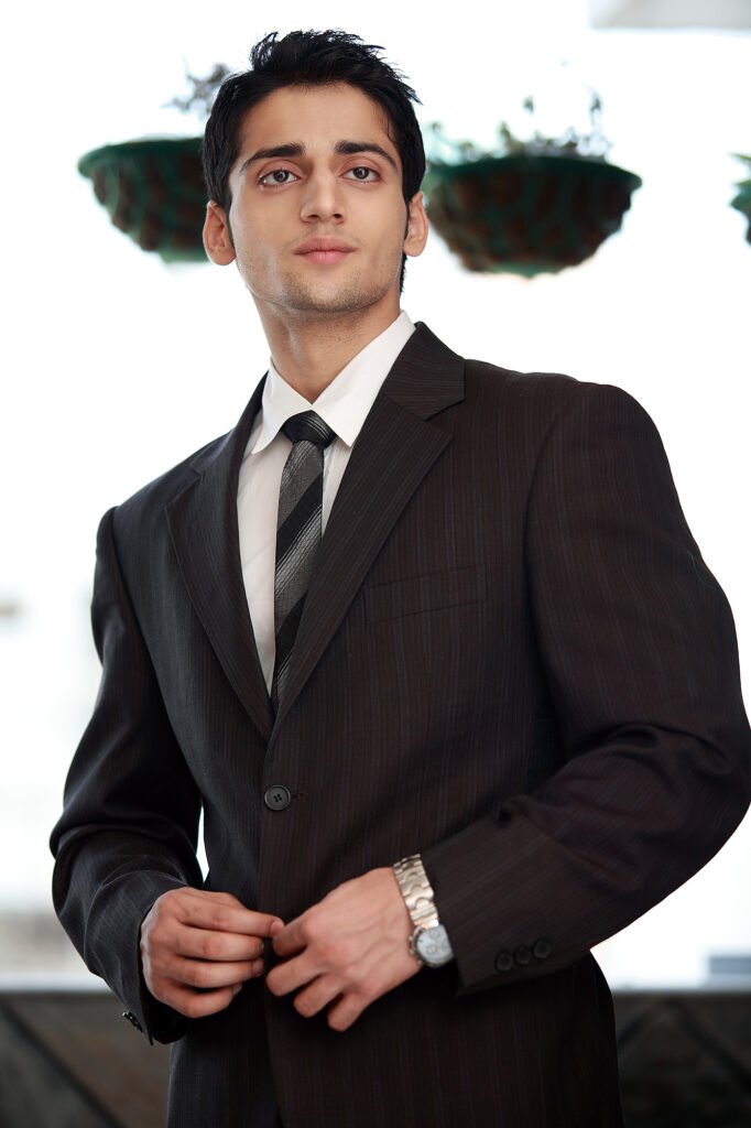 Male corporate model wearing a professional business suit and tie in a studio portfolio shoot by Auckland photographer Jassa Studio.