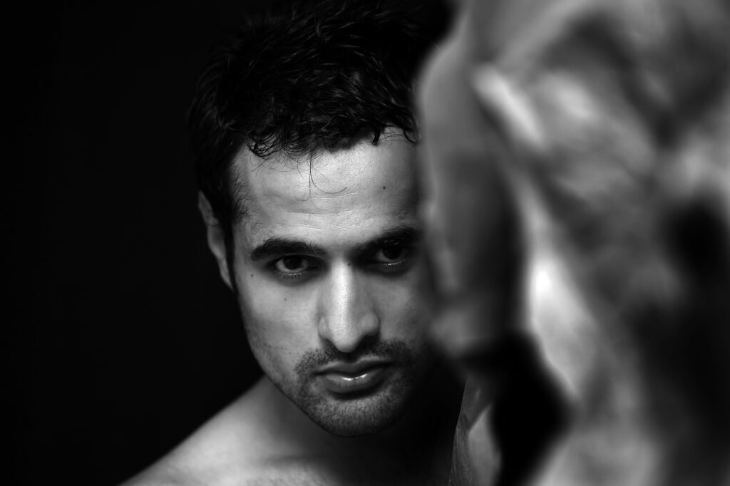 Dramatic black and white male model portrait featuring high contrast studio lighting by Auckland photographer Jassa Studio