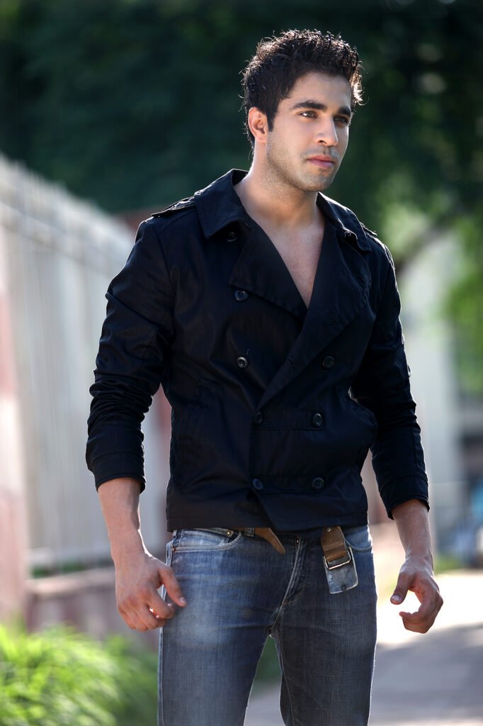 Male fashion model posing outdoors in a black jacket and jeans for a natural light lifestyle shoot by Auckland photographer Jassa Studio