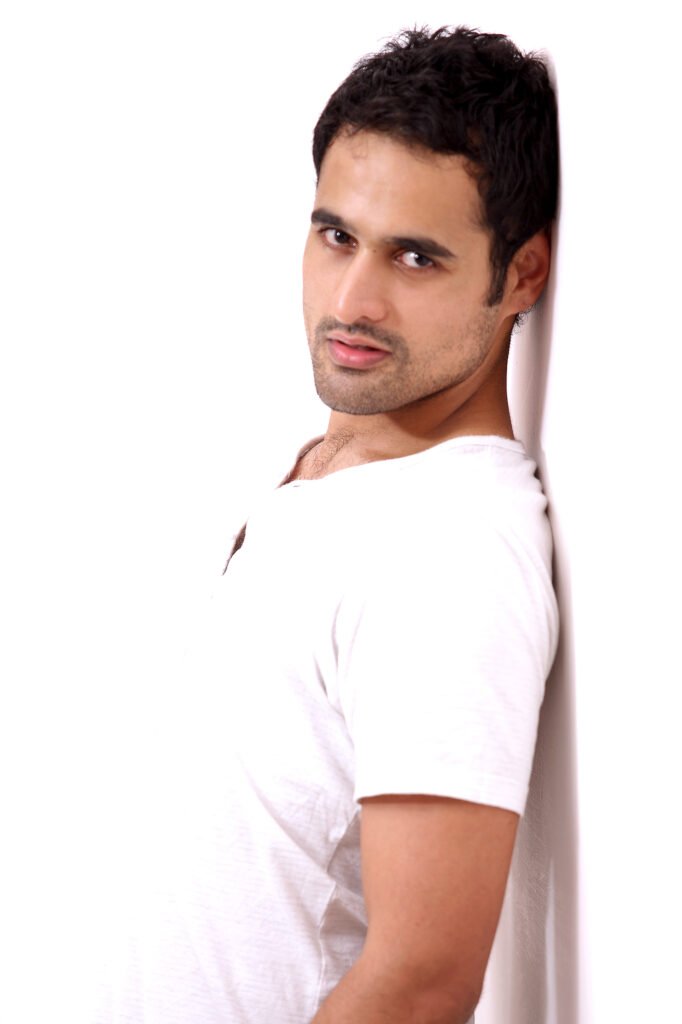 Australian actor Nicholas Brown posing in a white t-shirt against a clean studio wall backdrop for a commercial portfolio shoot by Auckland photographer Jassa Studio